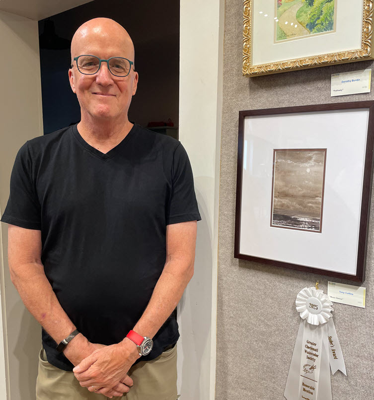 Tony Collins next to his Honorable Mention piece, "Moon Dance".